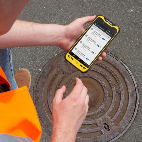 Trimble TDC600 inspecting manhole